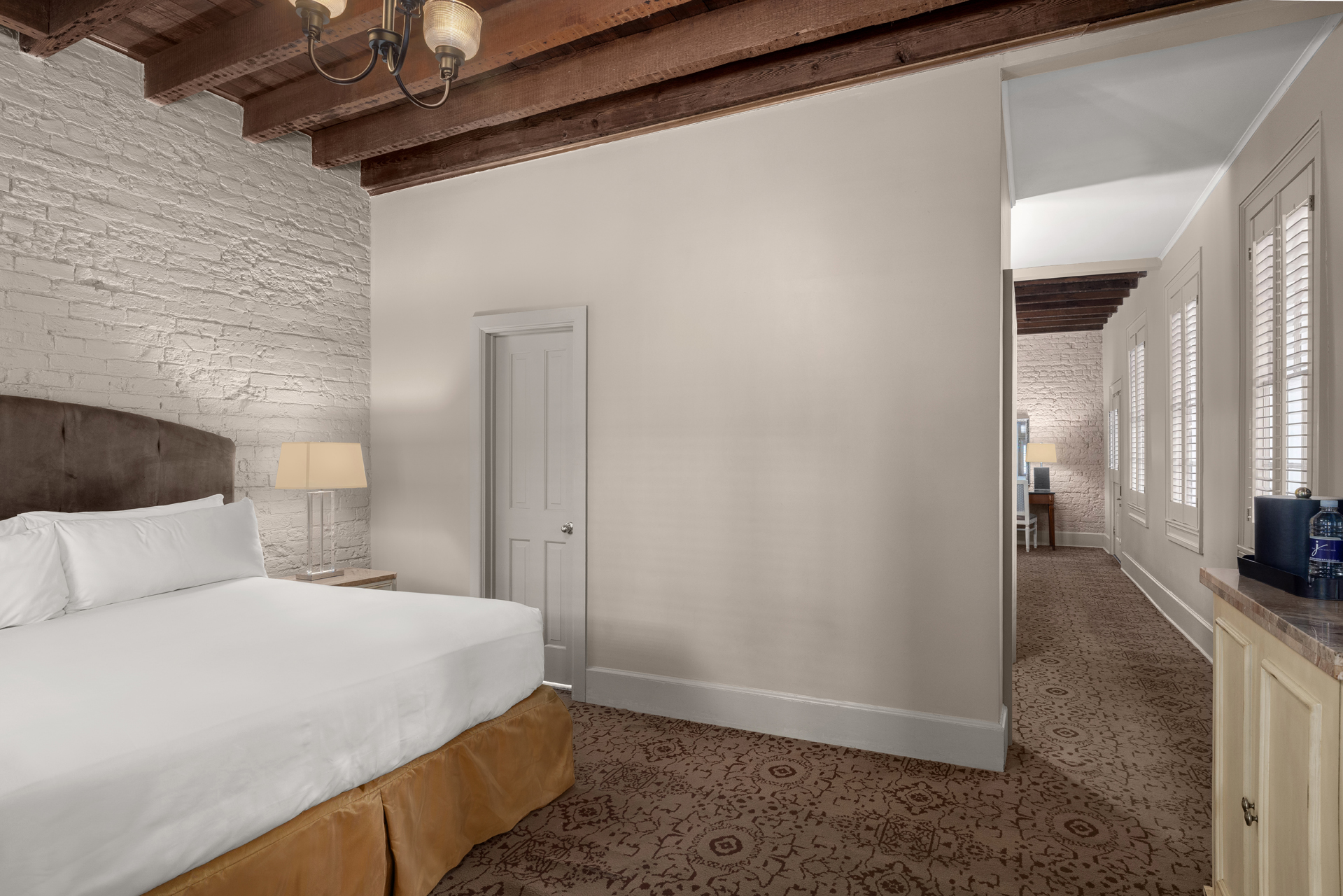 A hotel room with a bed, nightstand, and coffee maker